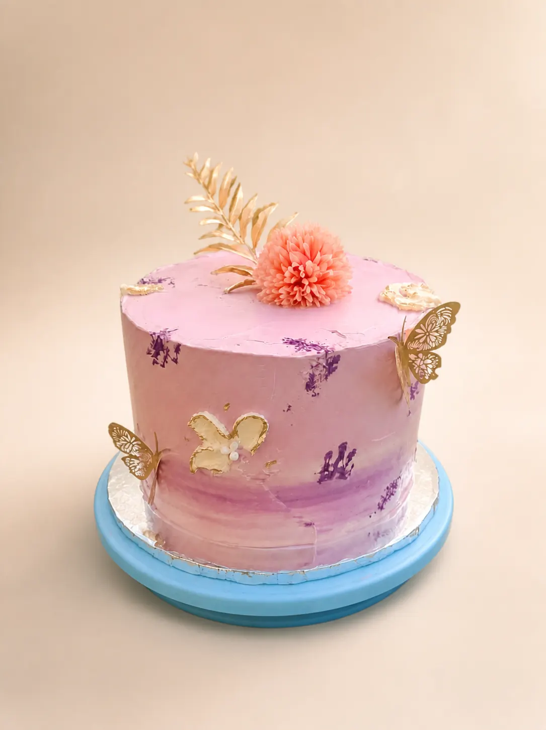 A two-tier vanilla cake on a stand