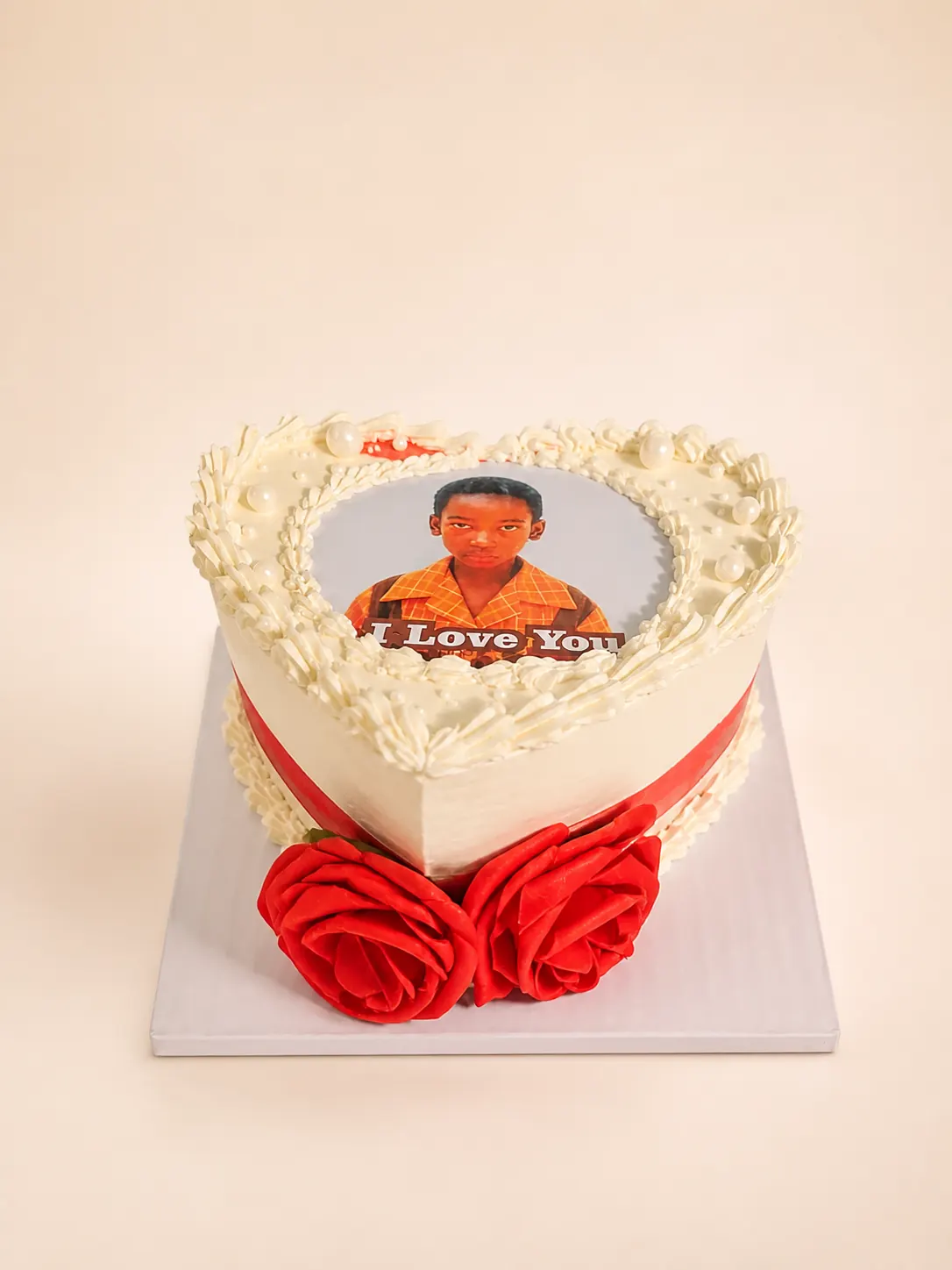A vanilla birthday cake with a printed topper